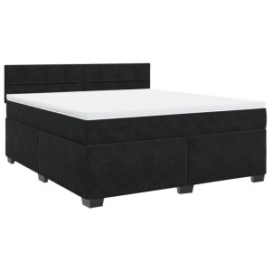 Schwarzes Boxspringbett 180x200 cm aus Samt mit gepolstertem Kopfteil und weißer Matratzenauflage.