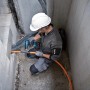 Handwerker nutzt Bosch Professional Akku-Heißluftgebläse GHG 18 V-50 zum Schrumpfen eines Kabels.