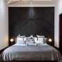 Schlafzimmer mit schwarzer Wandverkleidung aus Paneelen und indirekter Beleuchtung.