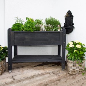 Schwarzes Wilk Premium Hochbeet 113x59x85cm aus Holz mit Kräutern und Ablage.