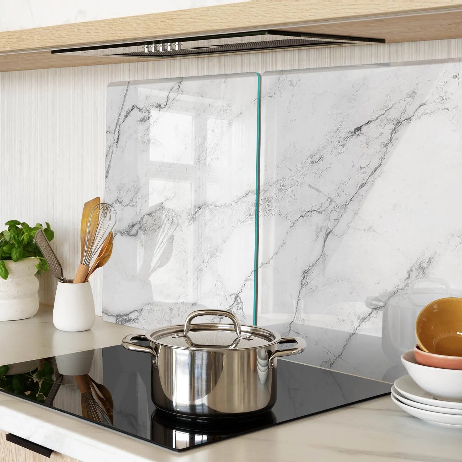 Zwei Tulup Glas-Herdabdeckplatten mit Marmor-Design als Spritzschutz in moderner Küche. Robuste Schutzplatte für Kochfelder.