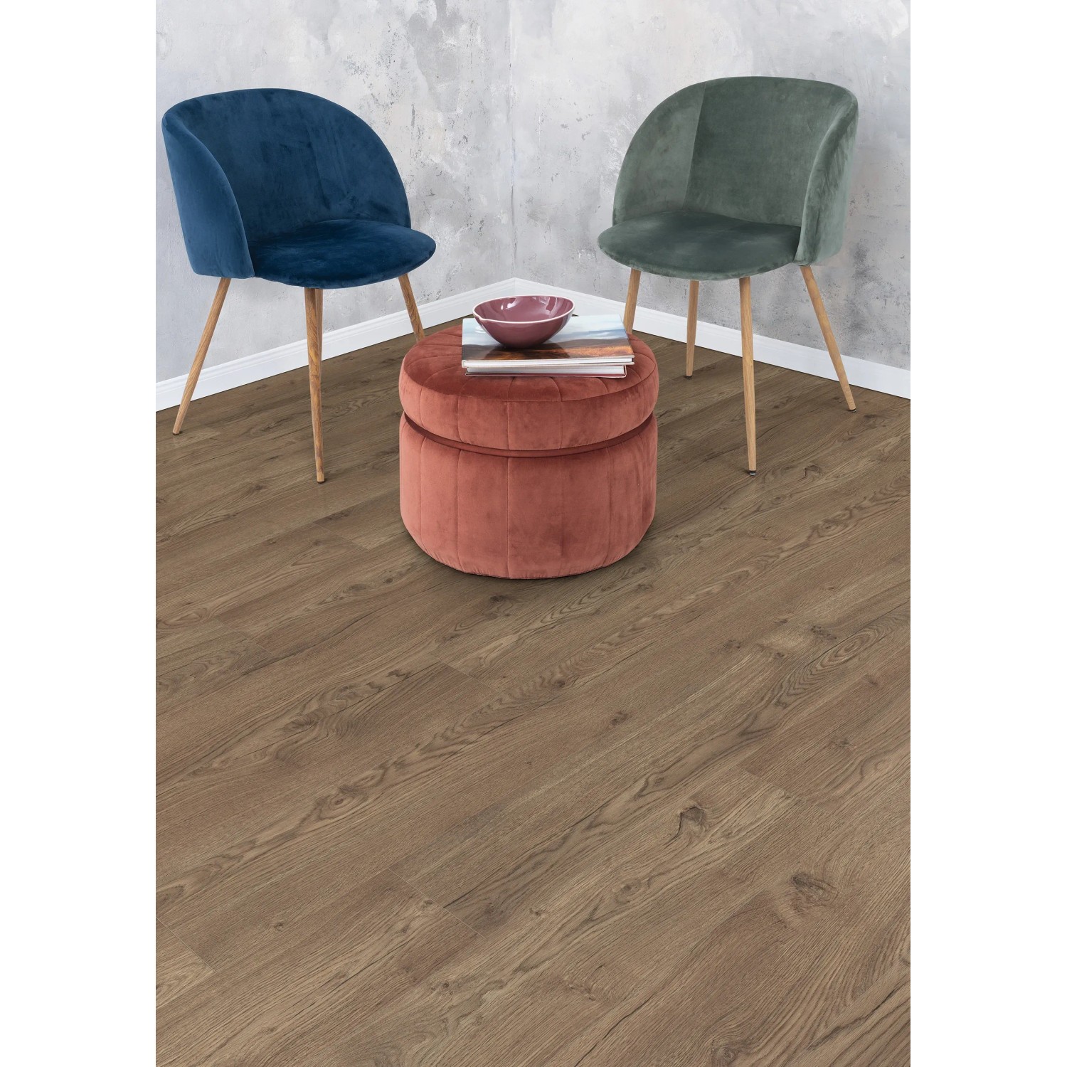 Egger NatureSense Aqua Laminat in Braun, verlegt in einem Raum mit Stühlen und Hocker.