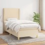 Cremefarbenes Boxspringbett 90x190 cm mit Matratze und hohem Kopfteil.