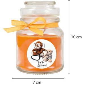Orange Duftkerze im Glas mit Schleife und "Bleib Gesund" Motiv.