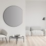Schwarzer DSK Design-Wandspiegel Picasso, Ø 100 cm, im modernen Wohnraum.