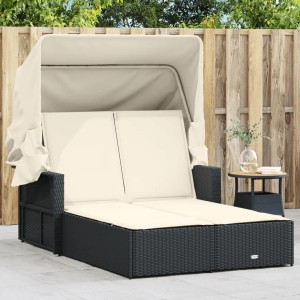 Schwarze Doppel-Sonnenliege mit Dach und cremefarbenen Auflagen aus Polyrattan.
