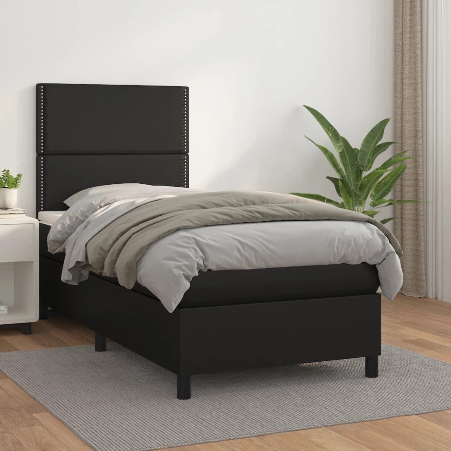Schwarzes Boxspringbett 90x190 cm mit Kunstleder und Matratze.