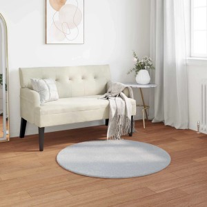 Runder grauer vidaXL Kunstfell-Hasen-Teppich Olite (Ø 120 cm) aus Polyester auf Holzfußboden.