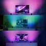 Philips Hue Play Wallwasher Doppelpack in Schwarz, verschiedene Farbszenen hinter TV.