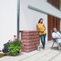 Garantia Wandtank Rocky 400 l Redstone mit Steinwand-Optik im Garten.