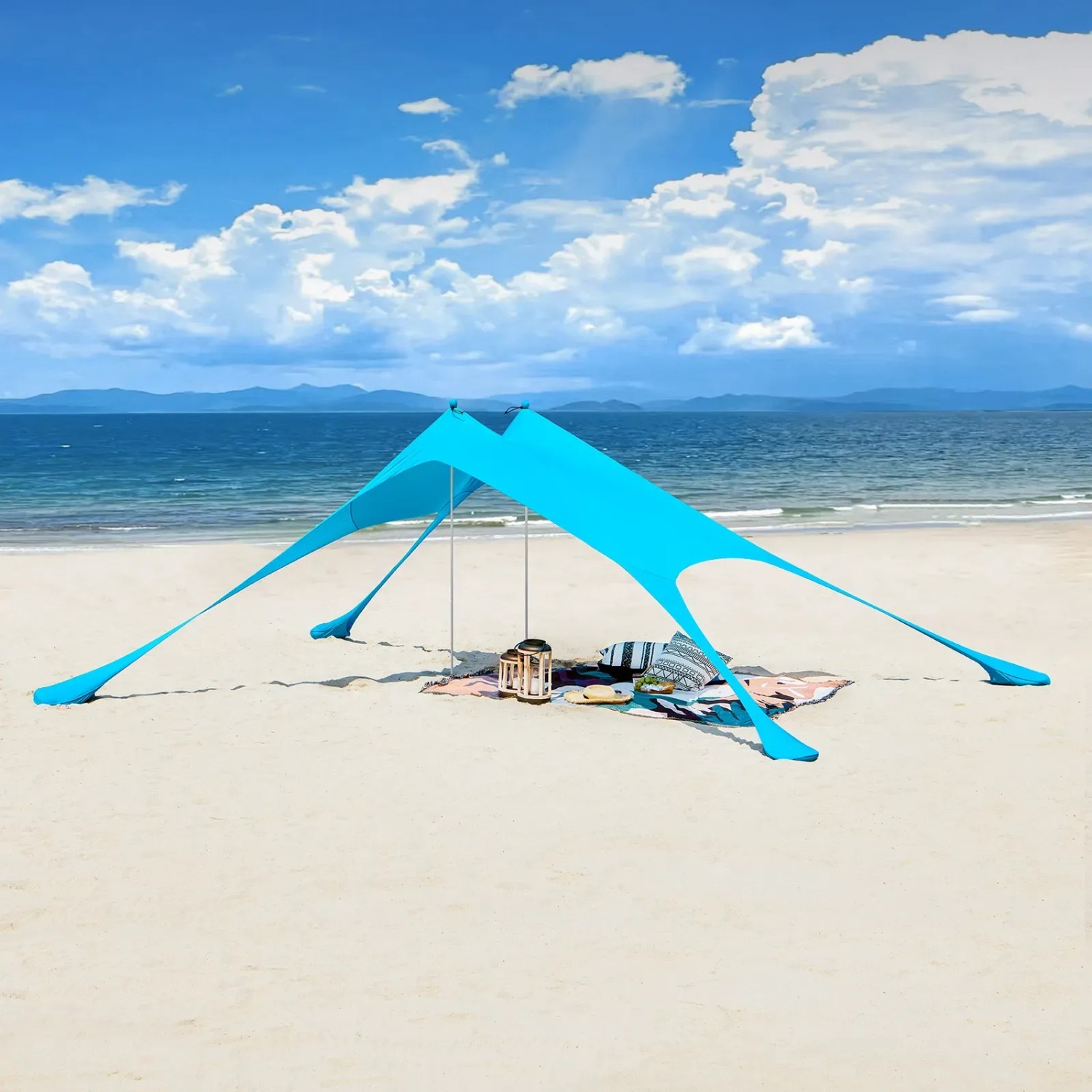 Blaues SoBuy Strandzelt/Sonnensegel mit Alustangen am Strand, mit Decke und Kissen.