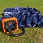Black+Decker Luftpumpe ASI400 (12V) beim Aufpumpen einer blauen Luftmatratze auf Rasen.