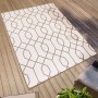 Rechteckiger, braun-beiger Primaflor In- und Outdoorteppich mit geometrischem Muster auf einer Holzterrasse.