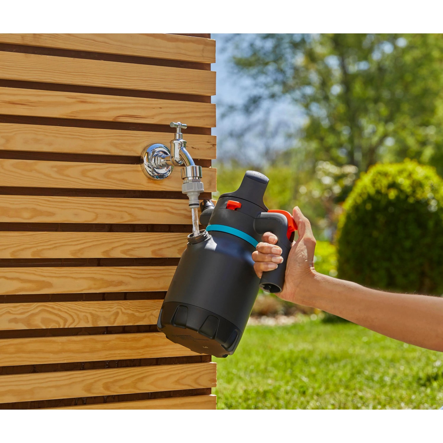 Gardena Drucksprüher 1,25 l beim Befüllen am Wasserhahn im Garten.