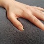 Nahaufnahme: Hand sinkt in flauschigen, anthrazitfarbenen Schöner Wohnen Badteppich Bali ein.