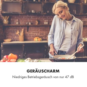 Frau kocht entspannt in moderner Küche, telefoniert. Die leise Klarstein Dunstabzugshaube ermöglicht ungestörtes Kochen. 47 dB.