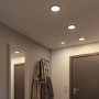Schwarze Paulmann LED Einbaupanels Areo VariFit, 11,8 cm, in einem Flur mit Garderobe.