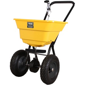 Texas Zentrifugalstreuer CS3600: Gelber Streuwagen mit luftbereiften Rädern für Dünger und Streusalz.