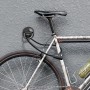 Basi Boden-Wandanker BWA 110 Schwarz mit Fahrrad gesichert an grauer Wand.