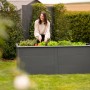 Westmann Hochbeet Primus aus Metall, 2x1m, anthrazit, mit Schneckenschutz. Frau erntet Salat.