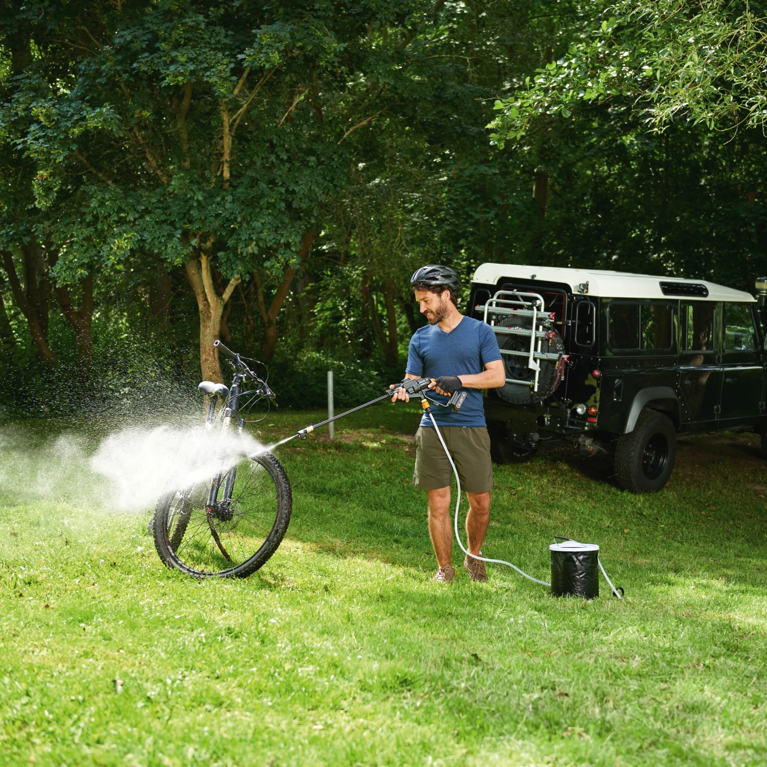 Worx Hydroshot Akku-Mitteldruckreiniger im Einsatz: Fahrradreinigung im Grünen mit Zubehör.