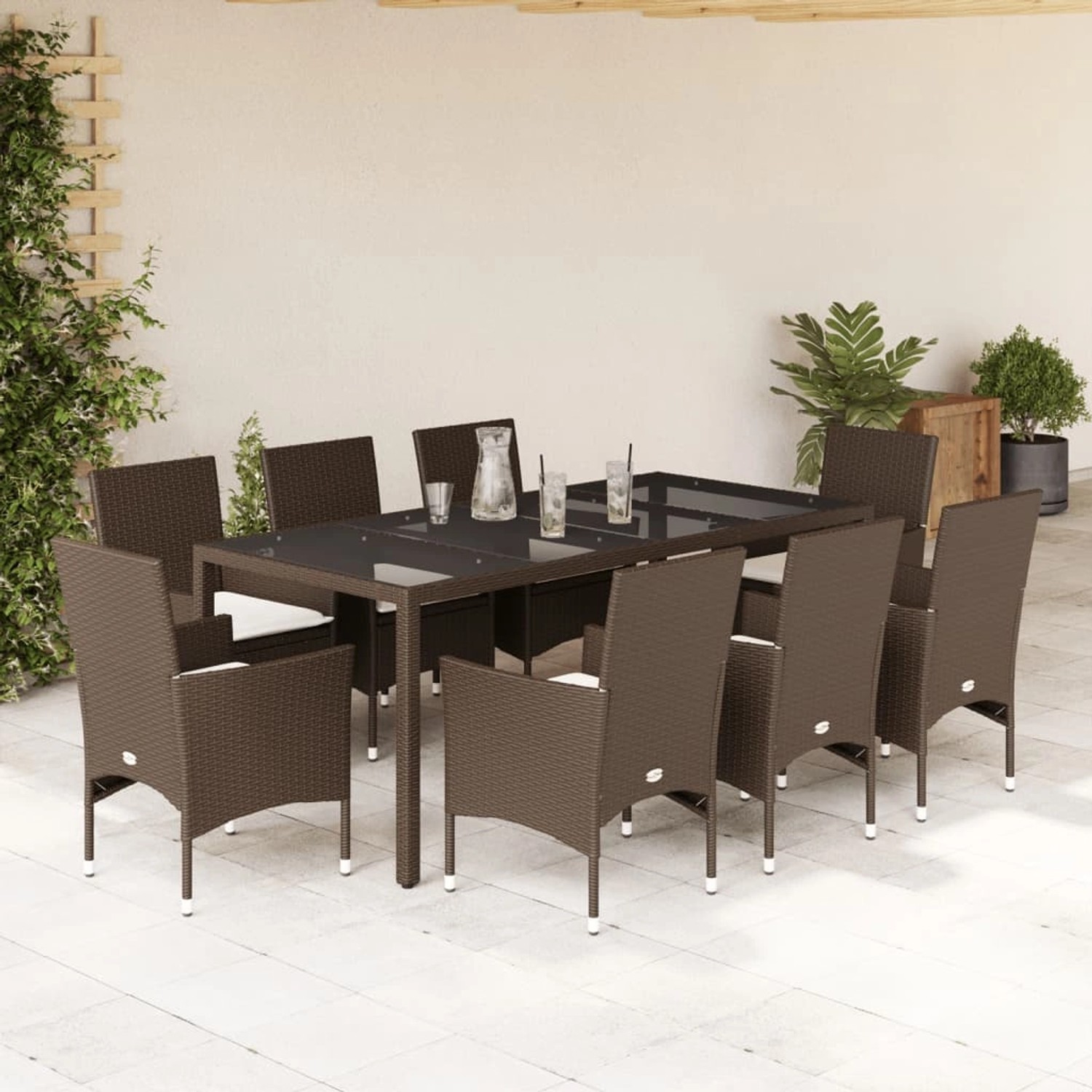 9-teilige Garten Essgruppe aus braunem Poly Rattan mit Glasplatte und Kissen.