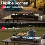 Evocamp Camping Gaskocher 2-flammig mit Grill und Gaskartuschen auf Campingtisch.
