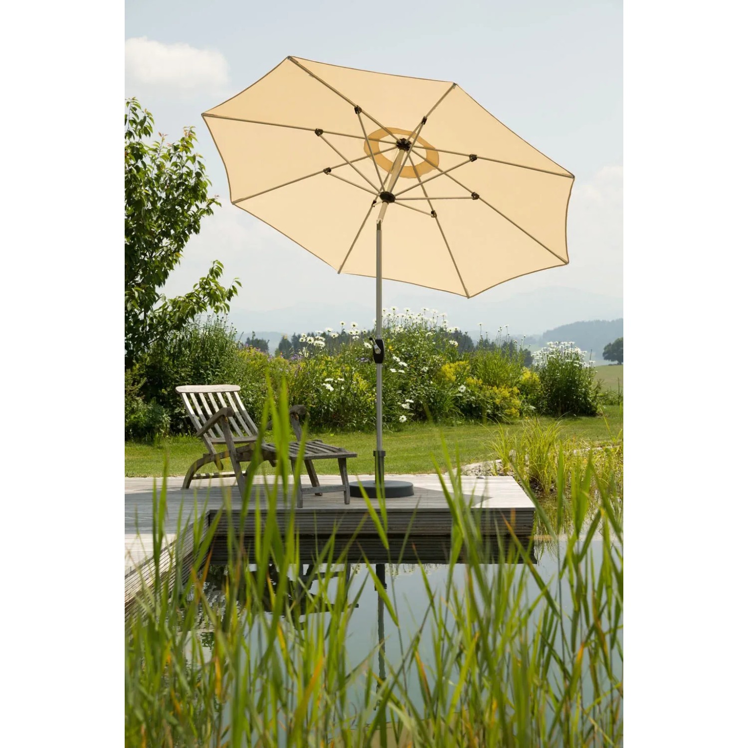 Naturfarbener Schneider Marktschirm Venedig Ø 270 cm mit Kurbel auf Terrasse am Wasser.