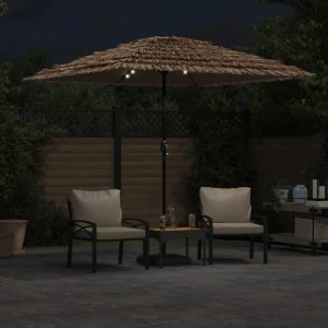 Brauner vidaXL Sonnenschirm mit LED-Beleuchtung und Strohdach, nachts auf der Terrasse. Schafft gemütliche Atmosphäre für Gartenmöbel.
