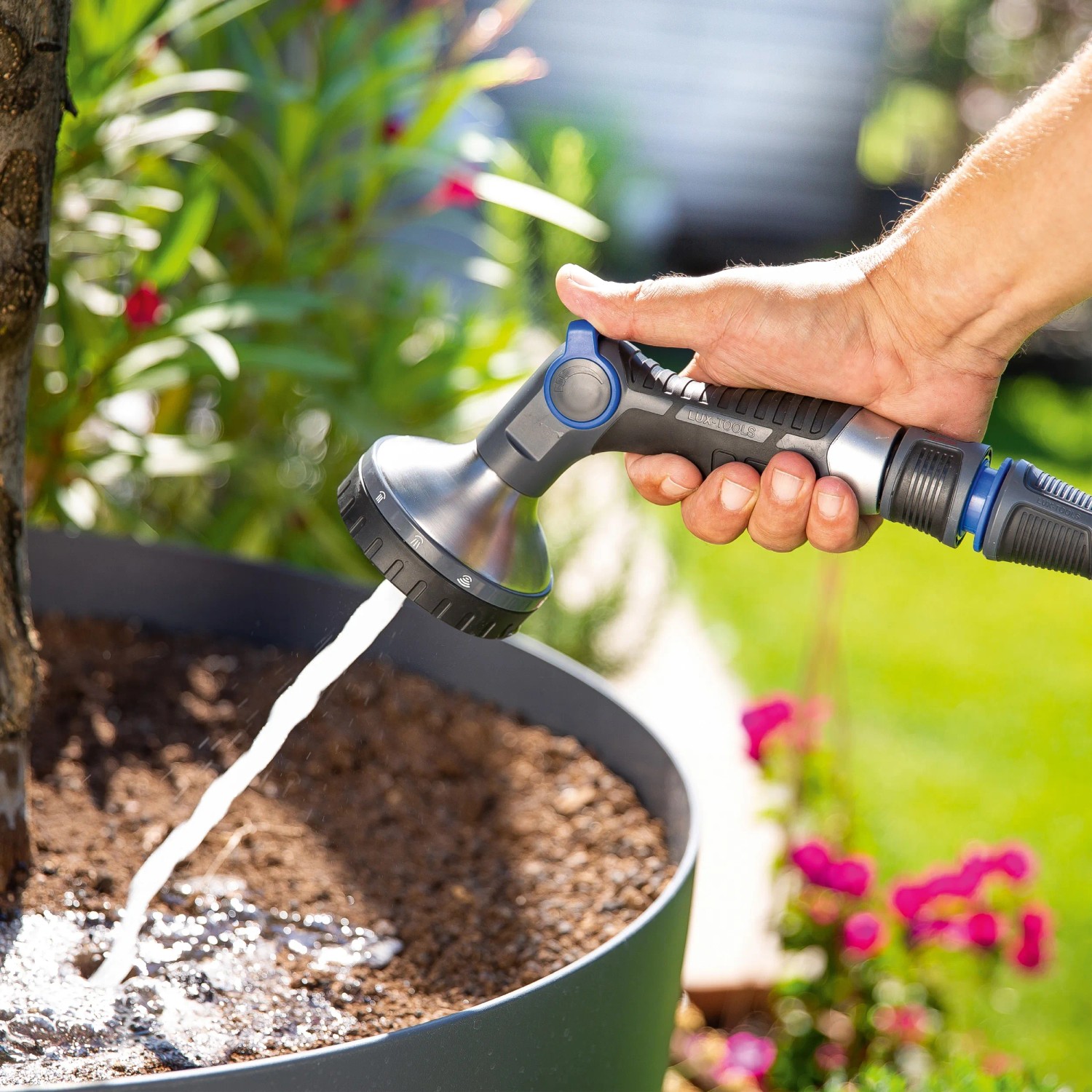 Hand bewässert Pflanze mit LUX Multifunktionsbrause (10 Strahlarten).