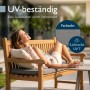 Hellgraue Beautissu Outdoor Bankauflage auf Holzbank, Frau entspannt im Garten. UV-beständig, waschbar, mit Fleckenschutz.