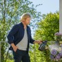 Mann benutzt Gardena Drucksprüher 1,25 l zur Pflanzenpflege auf dem Balkon.