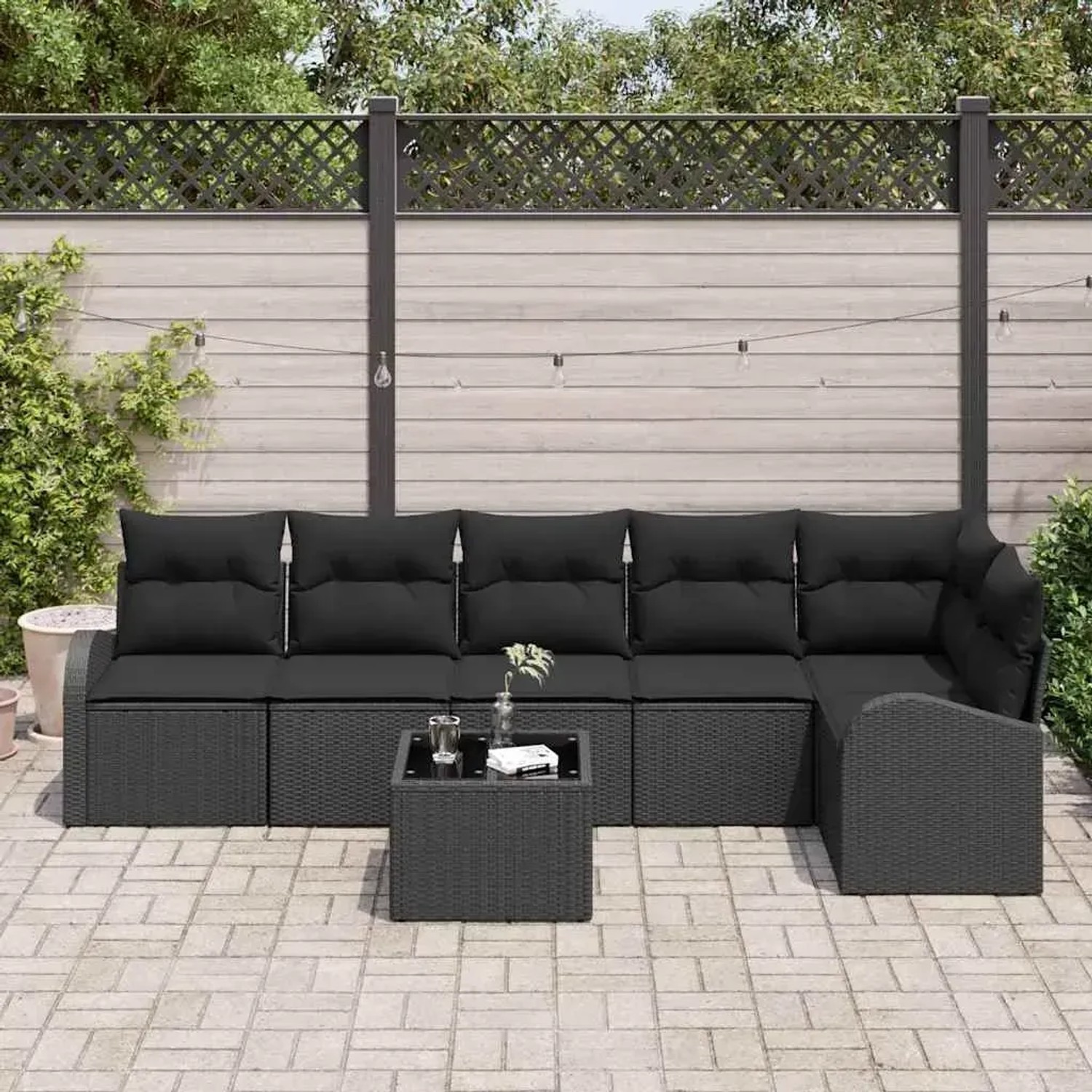 Schwarzes 7-teiliges vidaXL Garten-Sofa-Set aus Poly Rattan mit Kissen und Tisch.