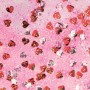 Glitzerkleber mit roten und silbernen Konfetti-Herzen auf rosa Hintergrund.