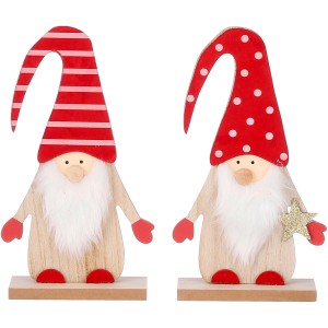 Zwei Holz-Weihnachtsmänner mit roten Mützen als Weihnachtsdekoration.