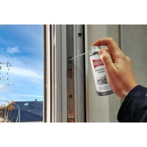 Hand sprüht Ballistol Zylinderspray 50 ml in ein Fensterschloss zur Schmierung und Pflege der Mechanik.
