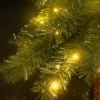 Detailaufnahme: Künstliche Doppel-Palme mit LEDs, grüne Blätter, warmes Licht.