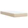 Cremefarbenes Boxspringbett 90x190 cm mit Matratze und Stoffbezug.