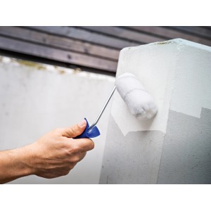 Hand lackiert mit LUX PRO Farbroller Lacke Grau einen Betonpfeiler.