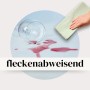 Apfelgrüne Sensalux Vlies-Tischdecke mit abgewischtem Rotweinfleck.