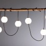 Paulmann LED-Lichterkette Naima Plug & Shine Basisset mit weißen Lichtkugeln an einem Ast. Warmweißes Licht.