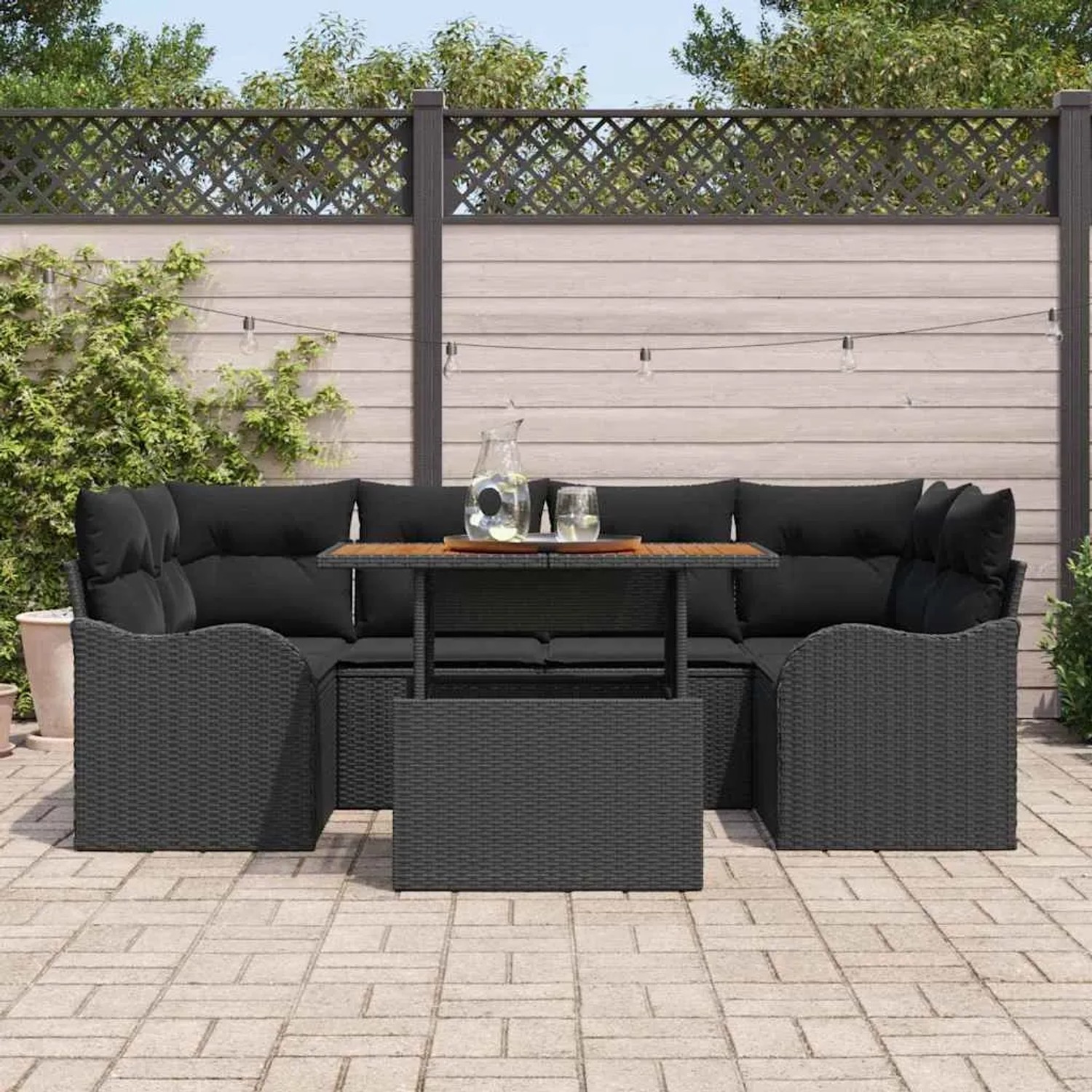 Schwarzes 7-teiliges Garten-Sofa-Set aus Poly Rattan mit Tisch und Stauraum.