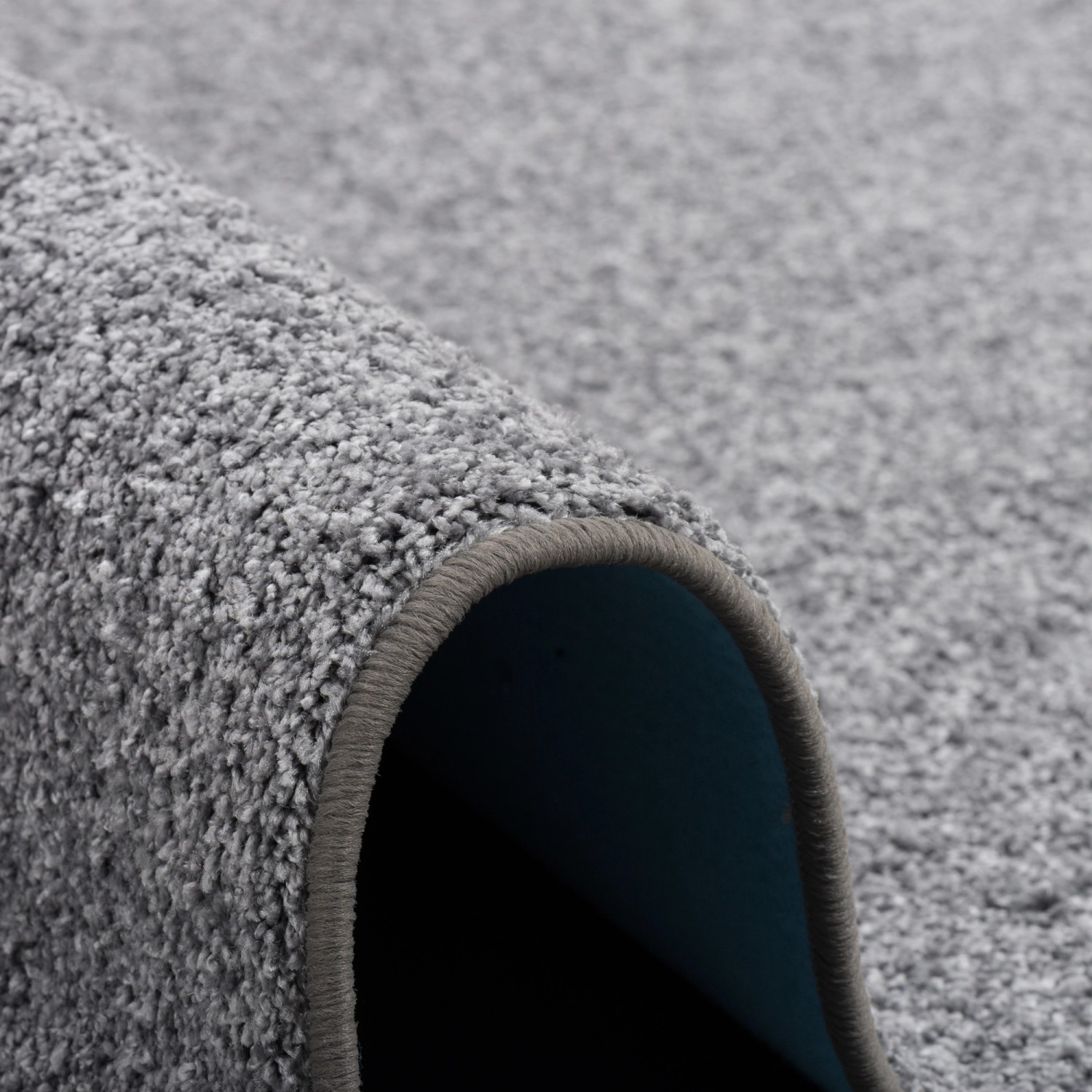 Grauer Snapstyle Hochflor Teppich Mona, 160x240 cm, Detailansicht der weichen Textur.