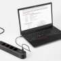Schwarze 4-fach Steckdosenleiste mit USB-Anschlüssen und Laptop.
