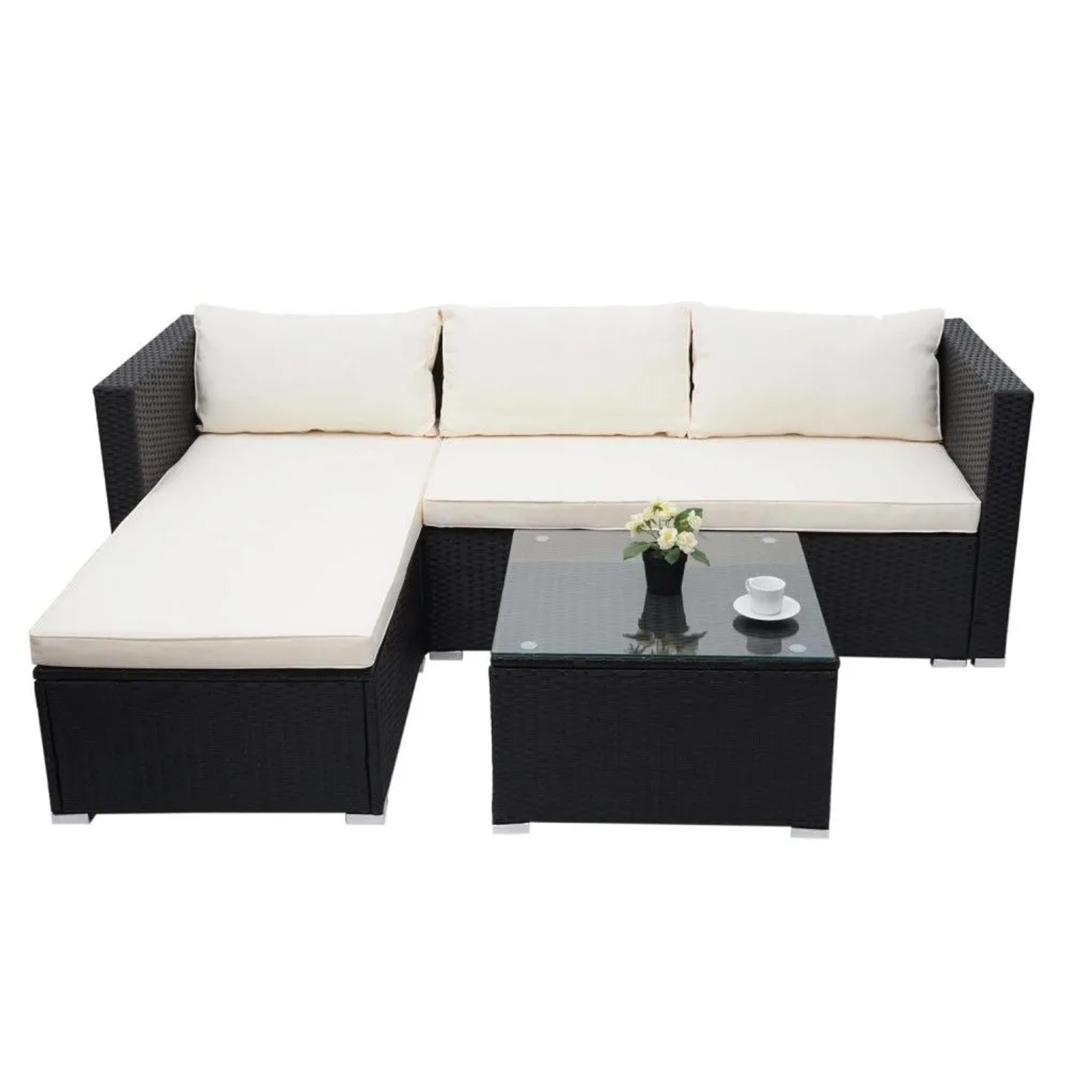 Schwarzes Poly-Rattan Gartenmöbel-Set mit L-Sofa, cremefarbenen Kissen und Glastisch. 3-teilige Lounge-Garnitur.