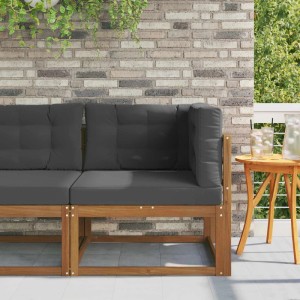 vidaXL Outdoor Ecksofa aus Akazienholz mit anthrazitfarbenen Kissen vor Ziegelwand.