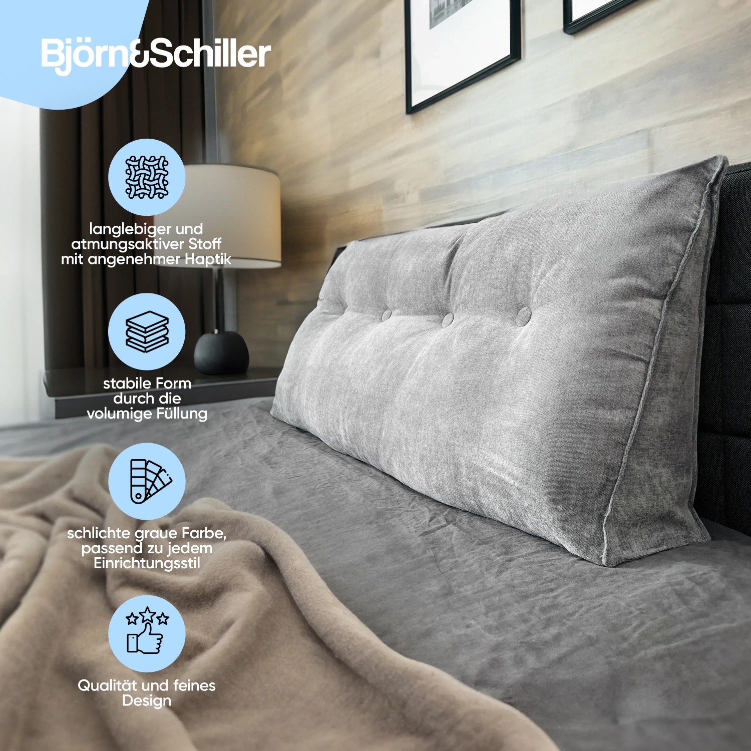 Graues Björn&Schiller Rückenkissen 70 cm mit waschbarem Bezug auf einem Bett.