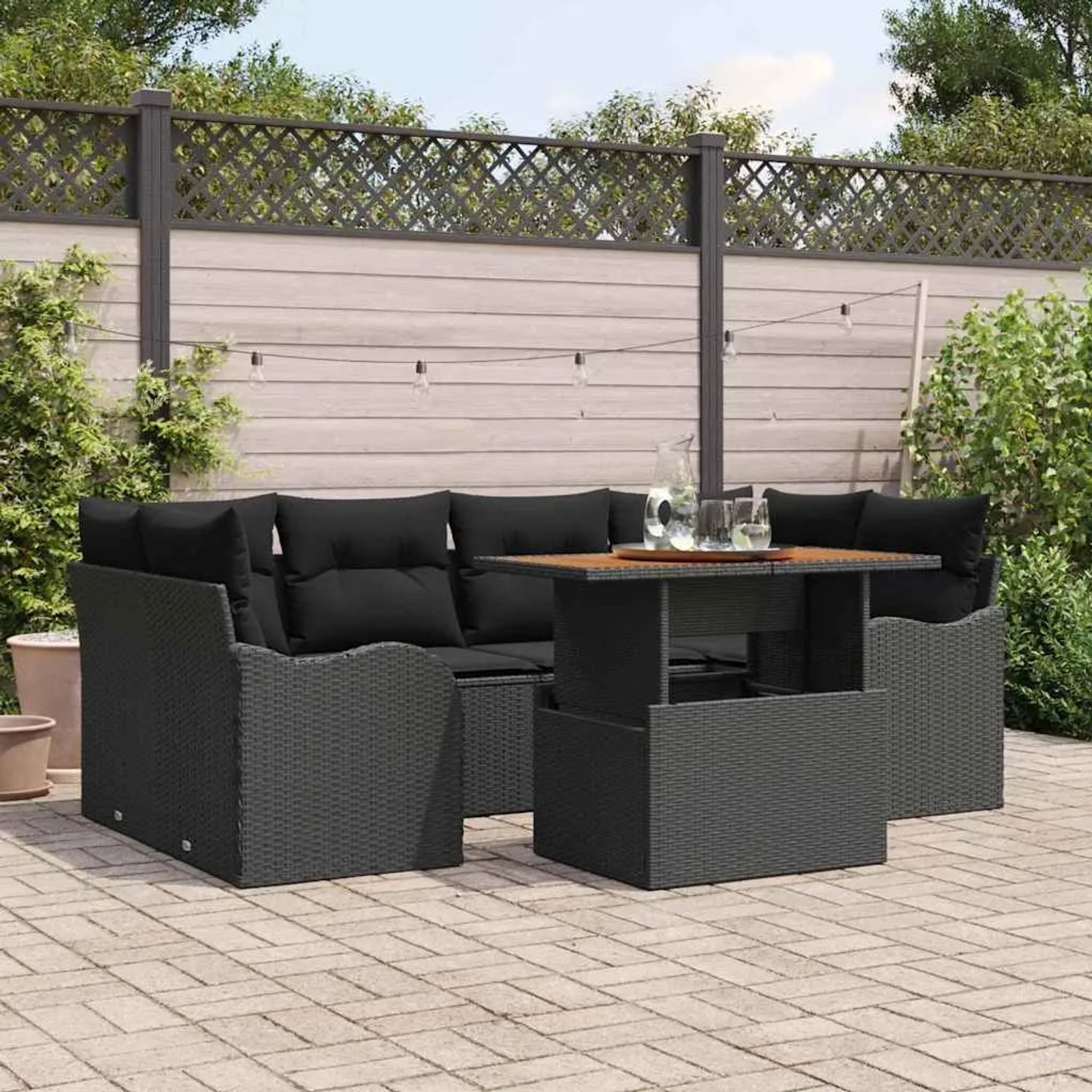 Schwarzes 7-teiliges vidaXL Garten-Sofa-Set aus Poly Rattan mit Stauraum und Tisch.