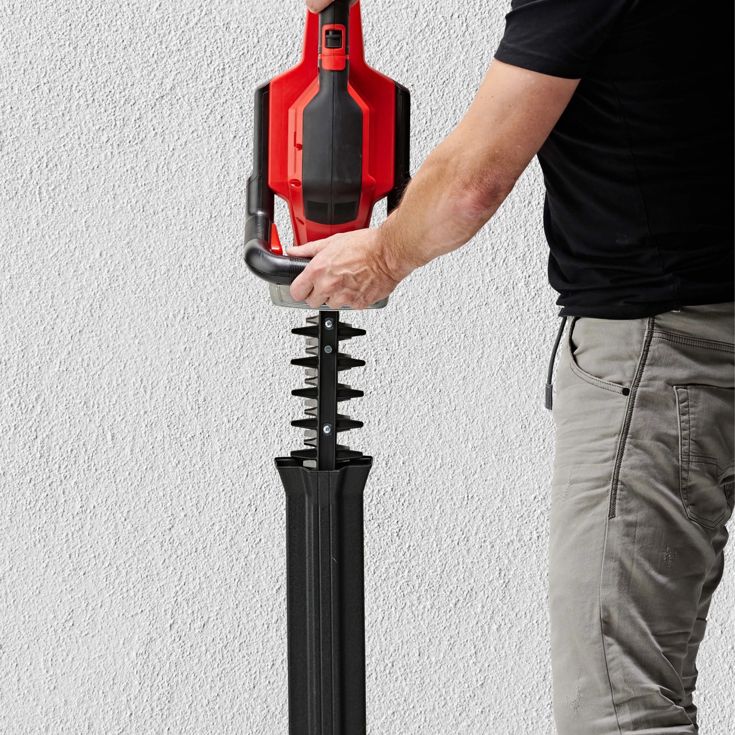 Einhell Akku-Heckenschere GE-CH 36/65 Li-Solo mit Messerschutz und Hand am Griff.