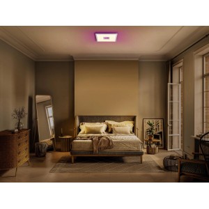 Ledvance Smart+ WiFi Panelleuchte Planon Plus mit farbigem Rücklicht in einem Schlafzimmer.